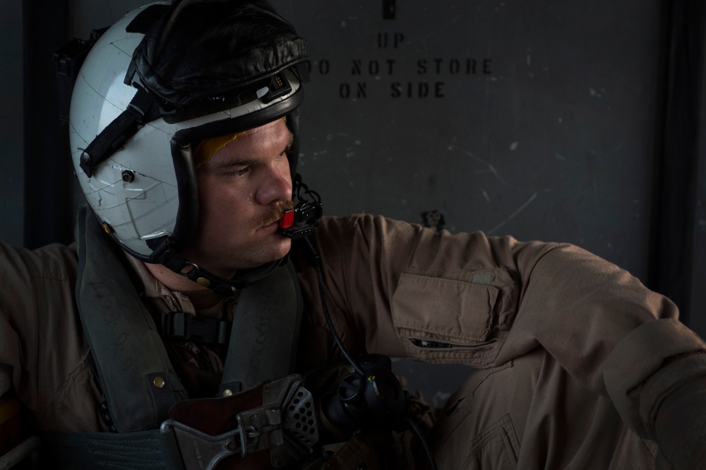 Naval aircrewman wearing a flight helmet with a boom microphone
